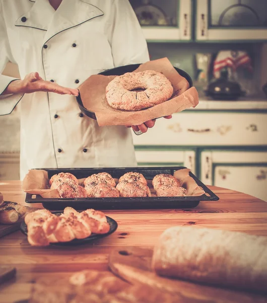 Woman cook with plate of homemade goods — Stock Photo, Image