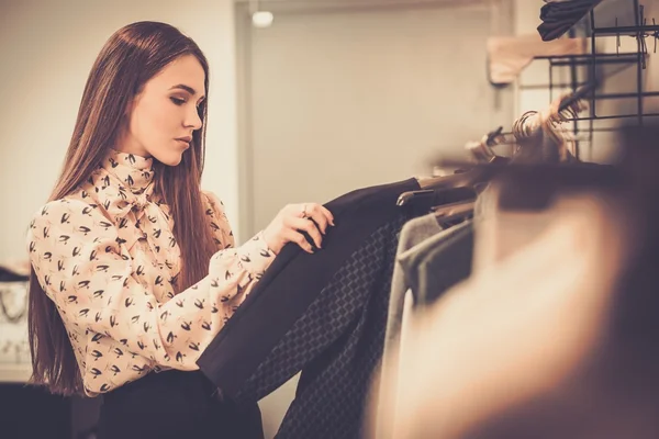 Mujer joven eligiendo ropa — Foto de Stock