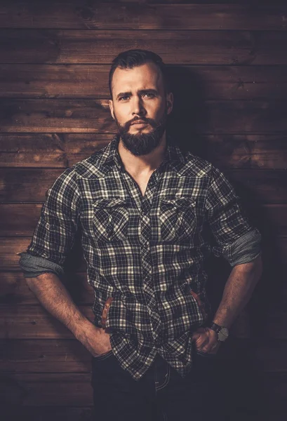 Man in checkered shirt, wooden house interior