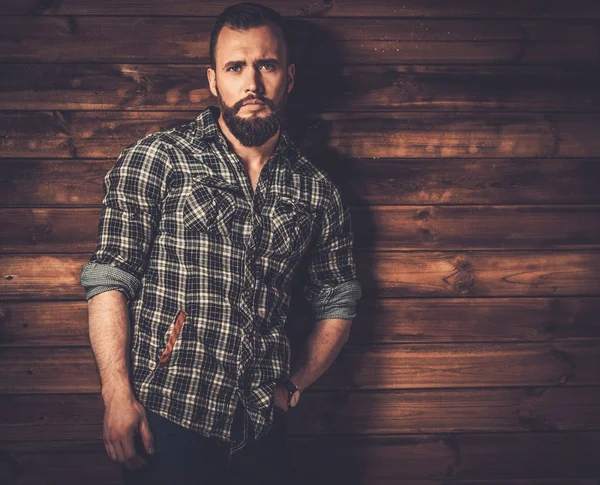 Man in checkered shirt, wooden house interior