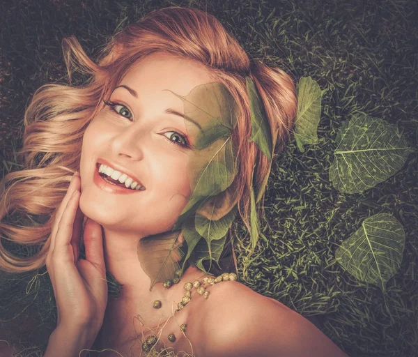 Dreaming woman lying on spring grass — Stock Photo, Image