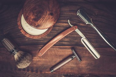 Shaving accessories on a luxury wooden background  clipart
