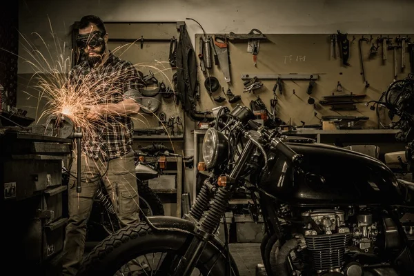 Mecânico fazendo trabalhos de torno na motocicleta alfândega garagem — Fotografia de Stock