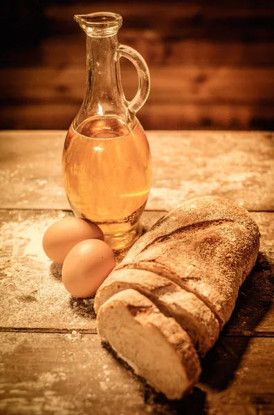 Homemade bread, oil and eggs on a table — Stockfoto