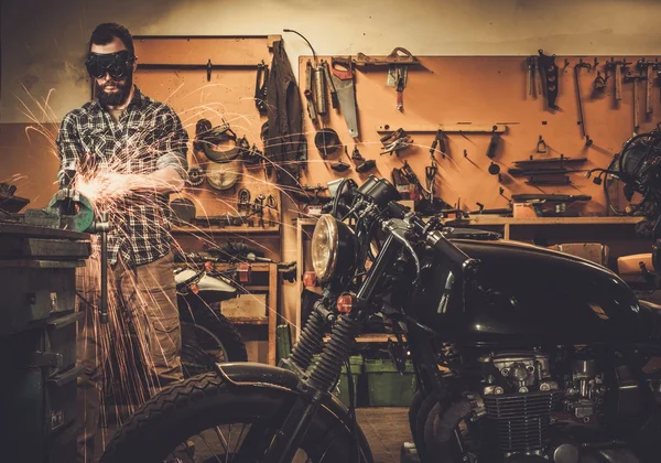 Mecânico fazendo trabalhos de torno na motocicleta alfândega garagem — Fotografia de Stock