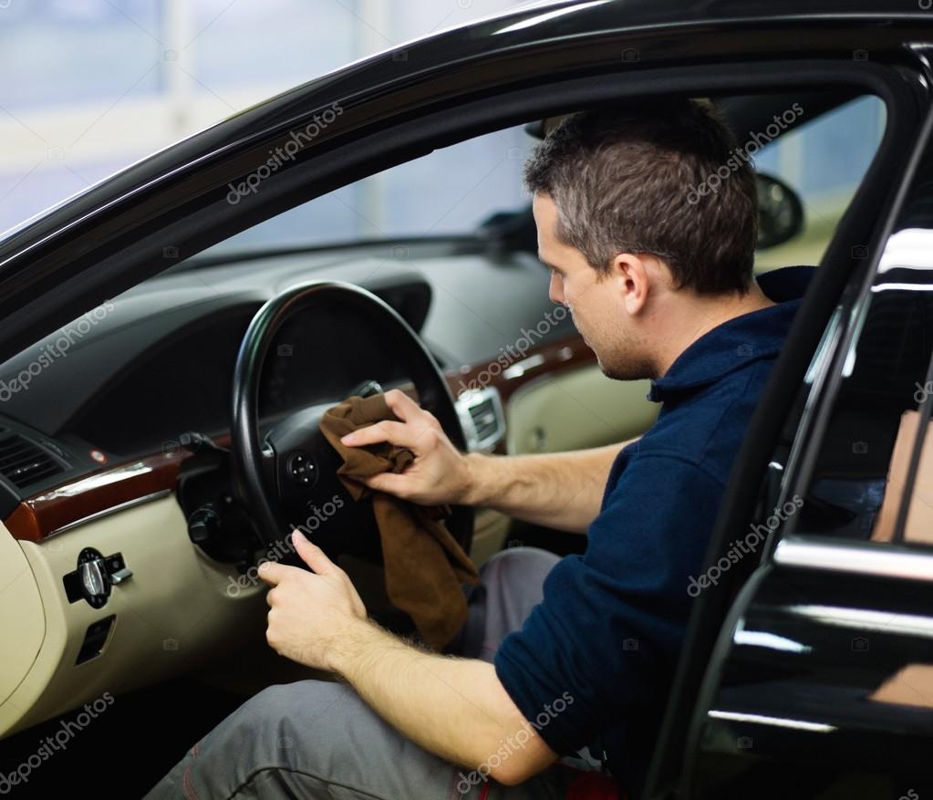 Worker On A Car Wash Cleaning Car Interior Stock Photo