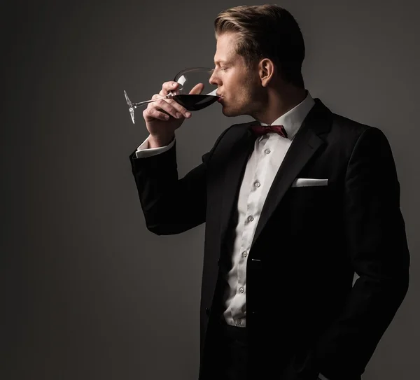 Confiado hombre vestido agudo con copa de vino —  Fotos de Stock