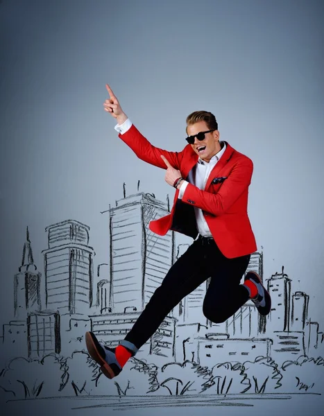 Stylish man jumping against city panorama drawing — Stock Photo, Image