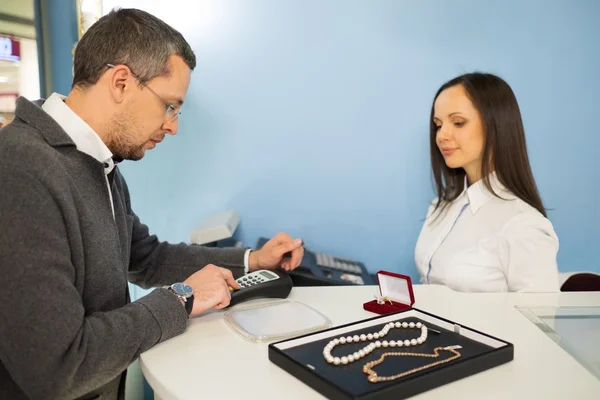 Man betalen met credit card in sieraden winkel — Stockfoto