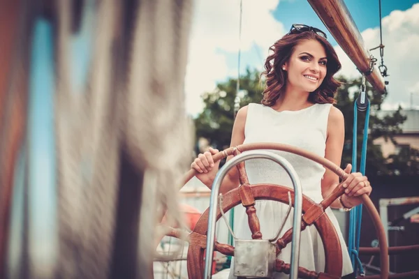 Stylish wealthy woman on a luxury wooden regatta — Stock Photo, Image