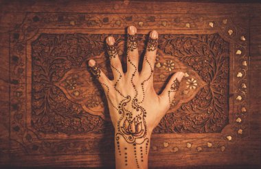 Woman's hand with traditional mehndi henna ornament clipart