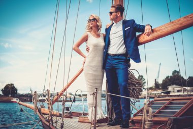 wealthy couple on a luxury yacht clipart