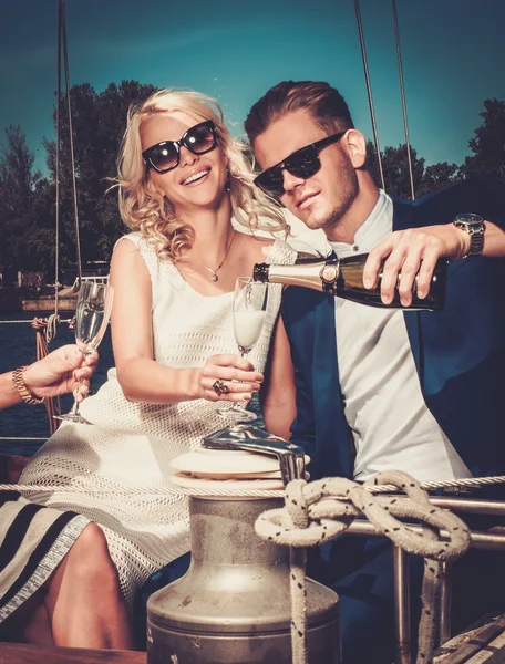 Stylish wealthy couple on a luxury yacht — Stock Photo, Image