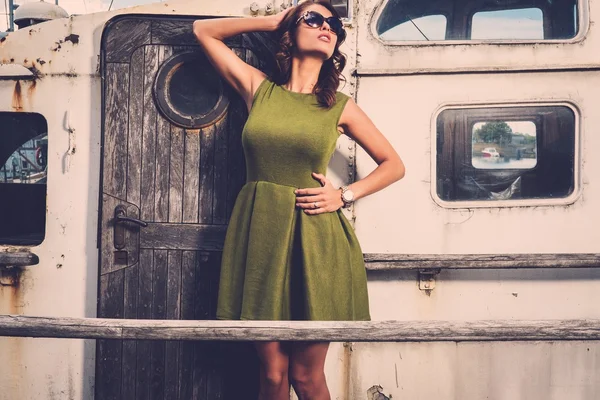 Stylish woman on old rusty boat — Stock Photo, Image