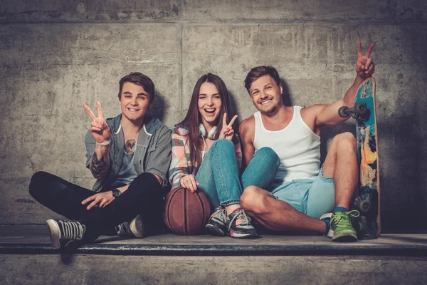 Cheerful friends with with skateboard and ball — Stock Photo, Image