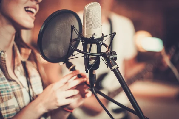 Женщина-певица в студии звукозаписи — стоковое фото