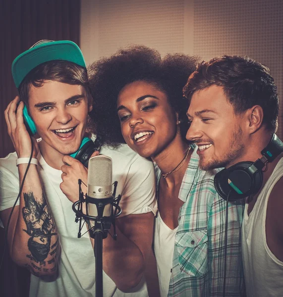 Multiracial music band performing in a recording studio — Stock Photo, Image