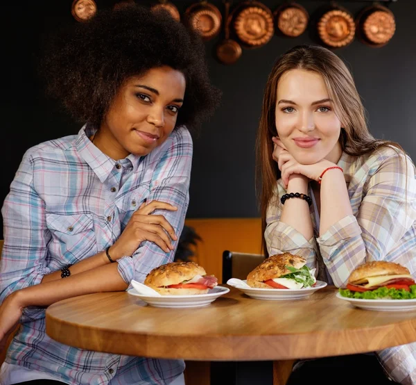 Glada multiracial flickor i ett café — Stockfoto