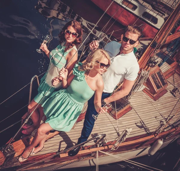 Stylish wealthy friends having fun on a luxury yacht — Stock Photo, Image