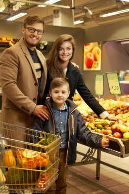 Young family in a grocery store clipart
