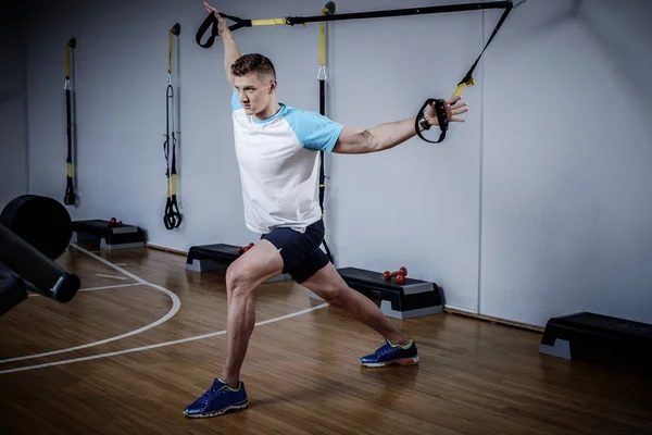 Man during workout with suspension straps — Stock Photo, Image