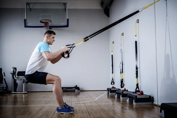 Man during workout with suspension straps — Stock Photo, Image