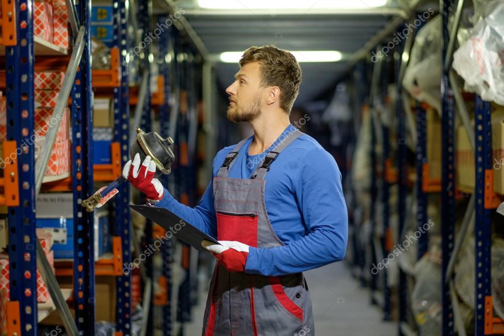 Worker on a automotive spare parts warehouse — Stock Photo © nejron