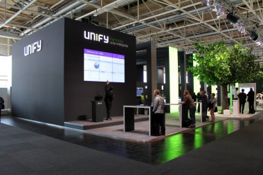 HANNOVER, GERMANY - MARCH 20: The presentation of Unify on March 20, 2015 at CEBIT computer expo, Hannover, Germany. CeBIT is the world's largest computer expo clipart