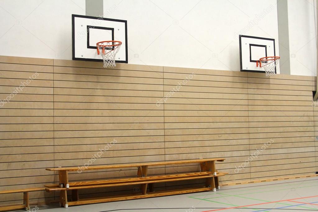 Wooden benches and basketball baskets in the gym