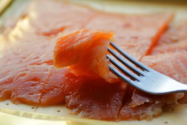 The smoked salted salmon on the fork