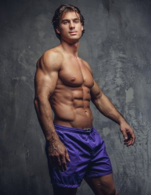 Gömleksiz kaslı adam mavi şort.
