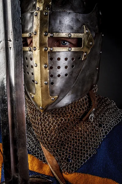 A knight with a sword and helmet — Stock Photo, Image