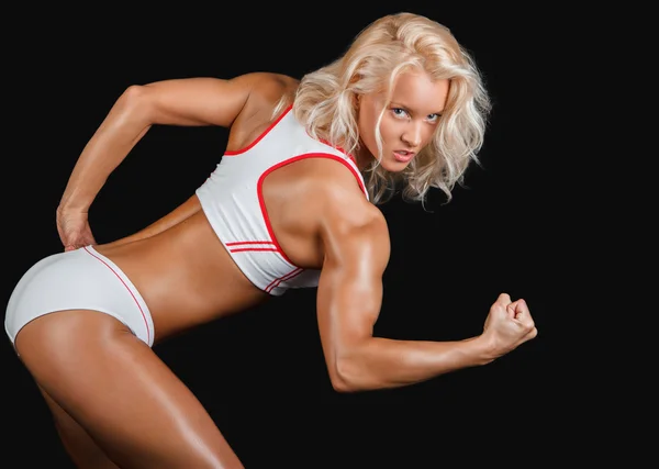 Blonde vrouw in een witte sexy sportkleding — Stockfoto