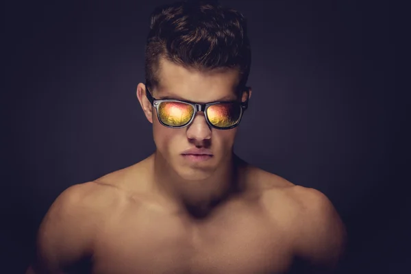 Homme musclé torse nu avec des lunettes de soleil — Photo