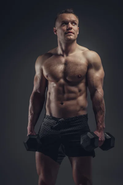 A man doing workouts with dumbbells. — Stock Photo, Image