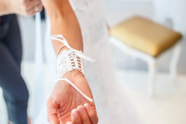 Wedding dress and woman's hand — Stock Photo, Image