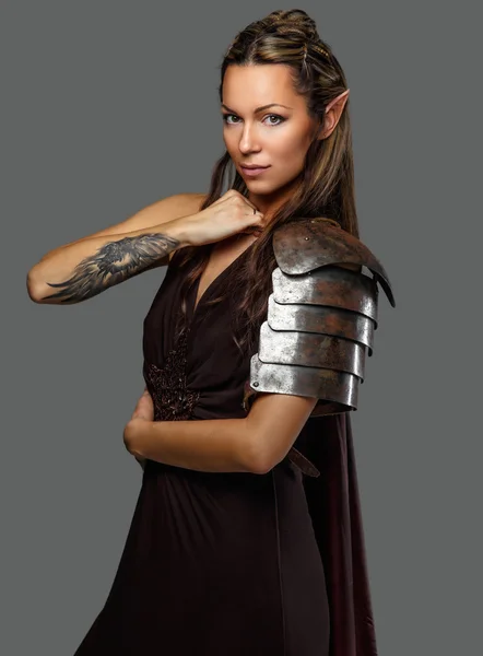 Woman in armour with tattoo on her hand — Stock Photo, Image