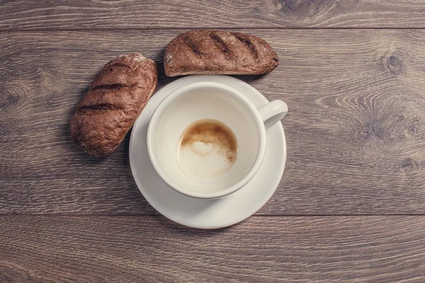 Bread and empy coffee cup. — Stock Photo, Image