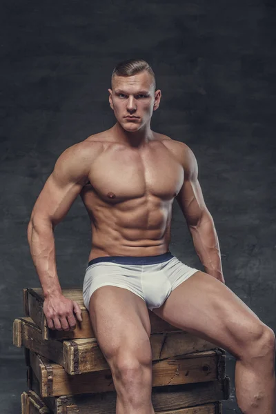 Shirtless muscular guy in a white panties — Stock Photo, Image