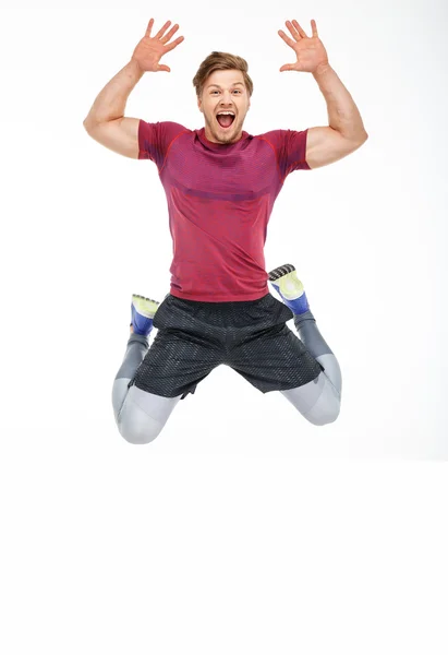 Sorridente uomo sportivo in un salto — Foto Stock