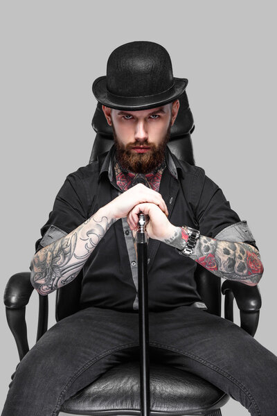 Bearded tattooed guy with walking stick