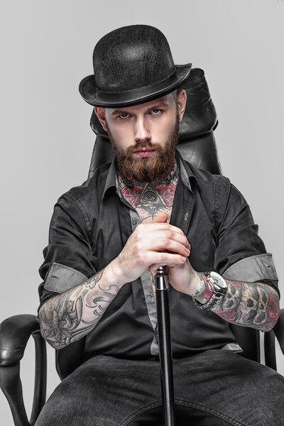 Bearded tattooed guy with walking stick