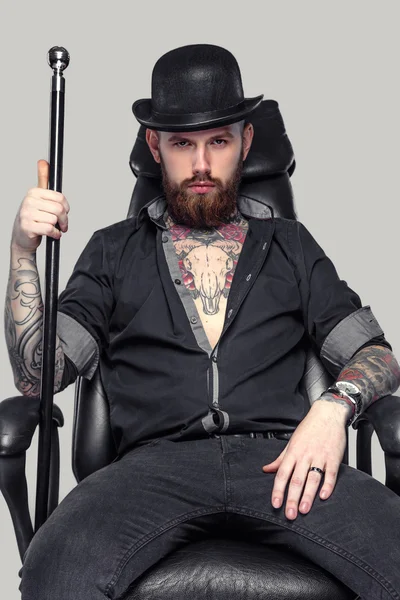 Bearded tattooed guy with walking stick — Stock Photo, Image