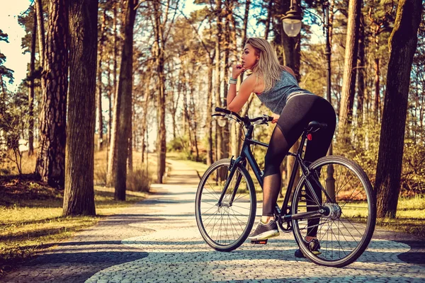 Sexy blond female on a bicycle — Stock Photo, Image