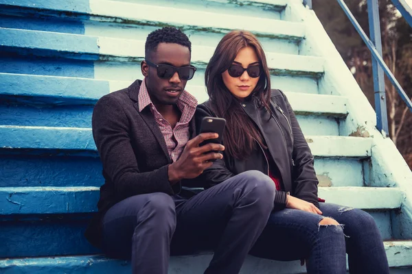 Male and female posing on steps — Stock Photo, Image
