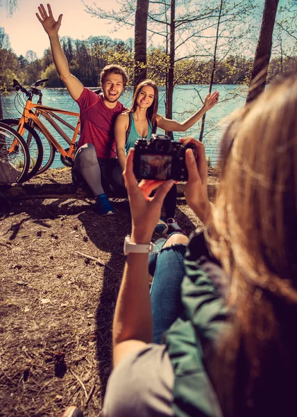 Blond female taking picture of couple. — Stock Photo, Image