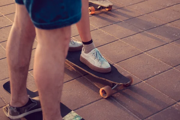 Patinadores urbanos piernas en longboards — Foto de Stock