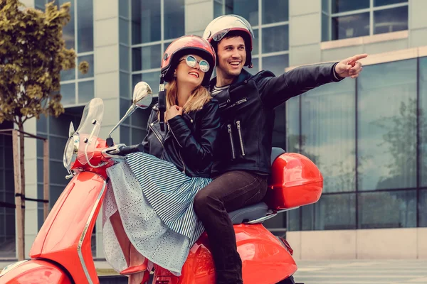 Male and female having fun on moto scooter. — Stock Photo, Image