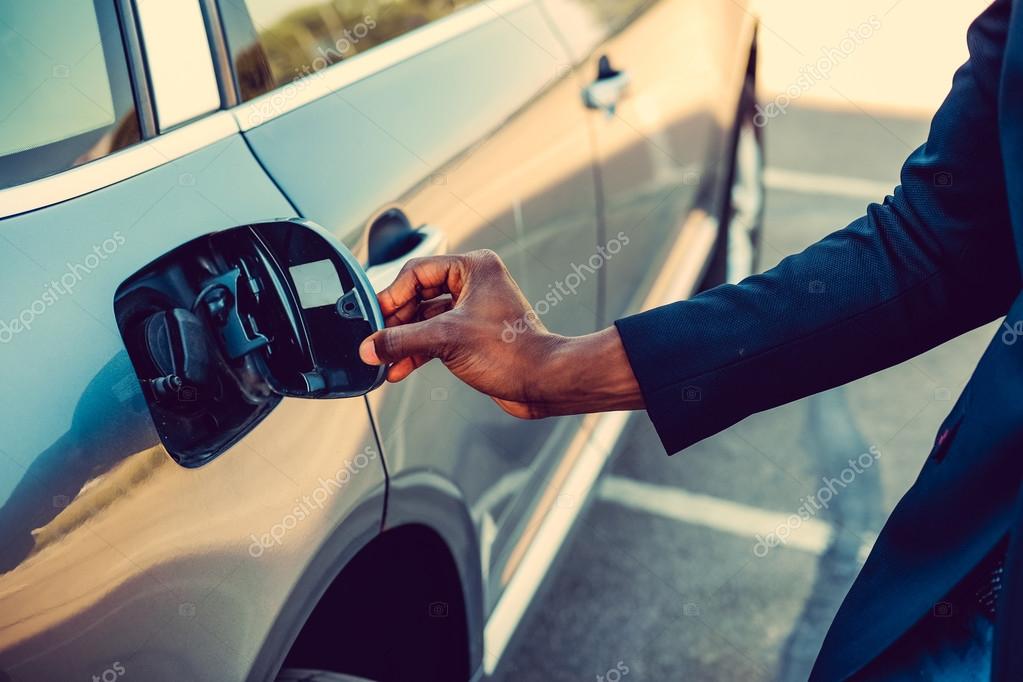 Black man is opening gas tank Stock Photo by ©fxquadro 112240478
