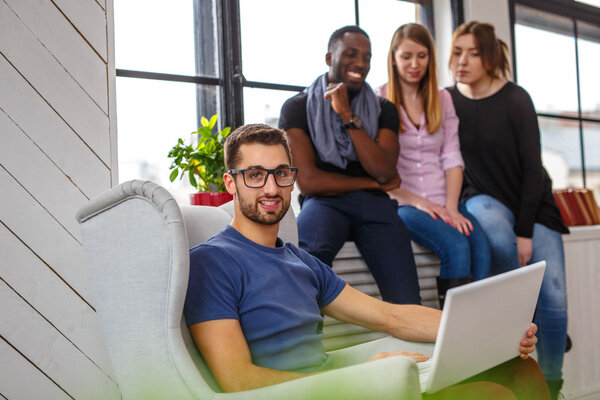 Multi ethnic students using laptop